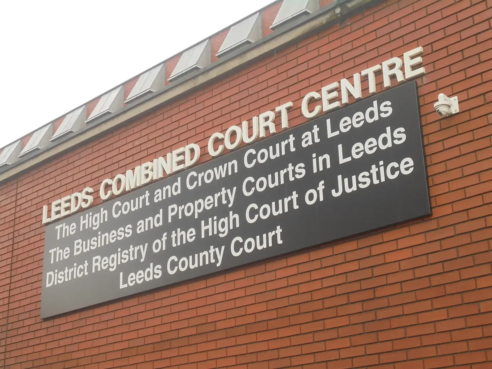 Sign for the Leeds Combined Court Centre listing the High Court and Business and Property Courts